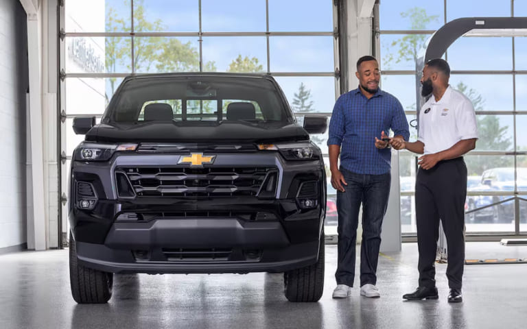 Customer walking near a Chevrolet SUV while exploring lease-end options
