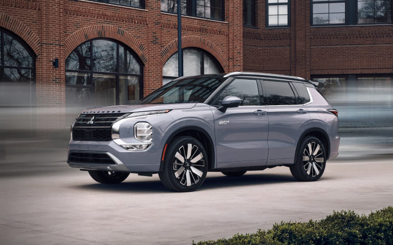 Driver stepping out of a Mitsubishi SUV before selling or trading a vehicle