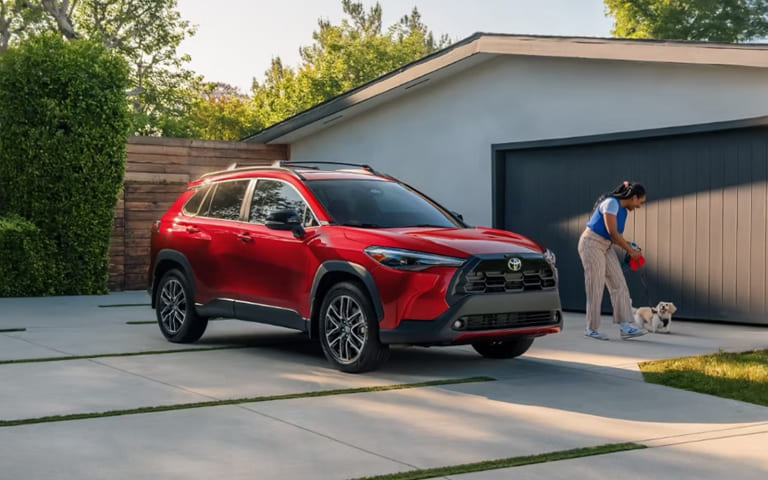 Driver stepping out of a Toyota SUV before selling or trading a vehicle