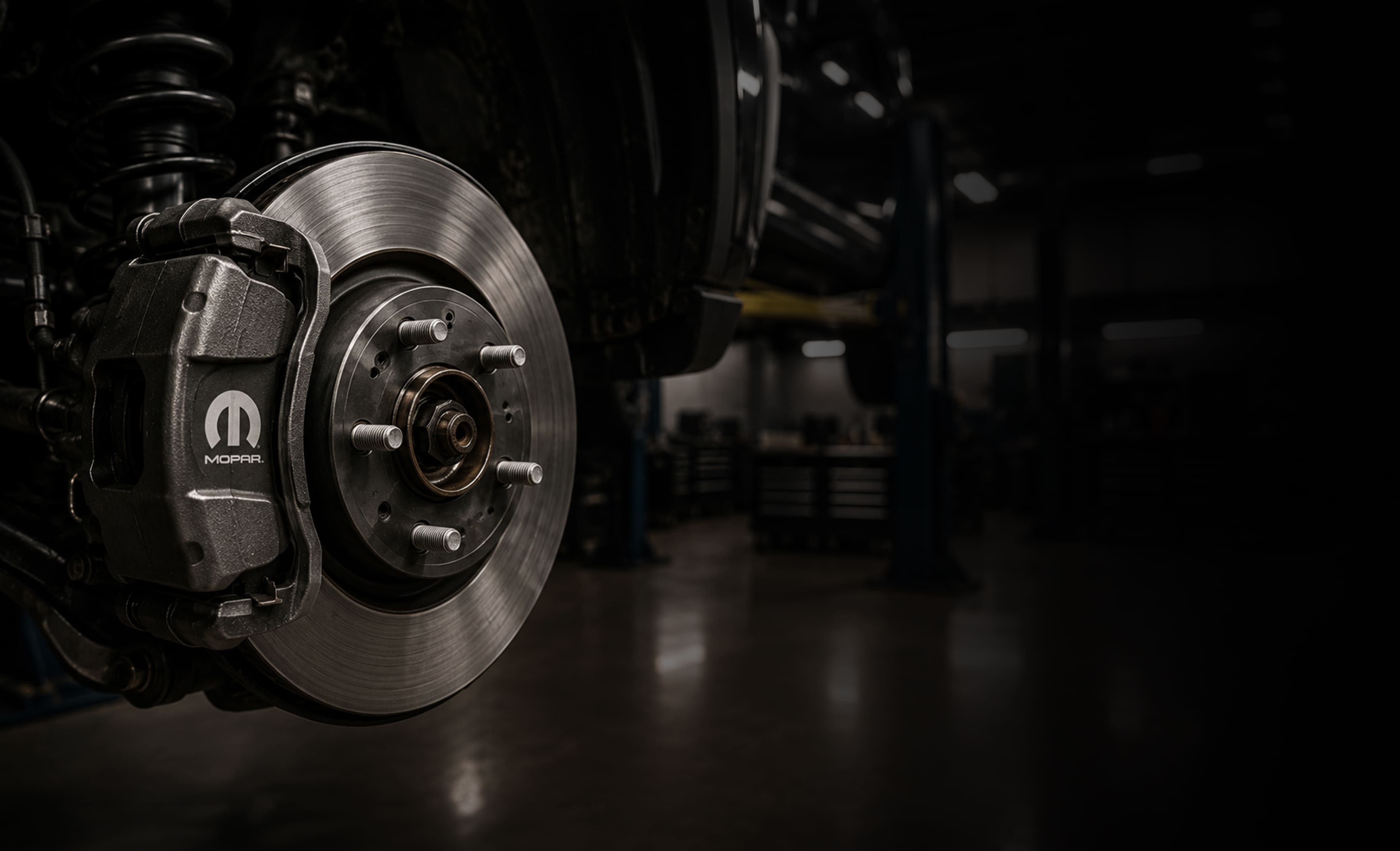 Close-up of a vehicle brake rotor and caliper during brake service near Monroeville and McKeesport, PA